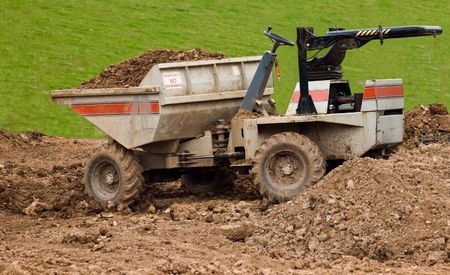 a dumper truck illegally left with its bucket full, keys in the ignition and its roll bar folded...