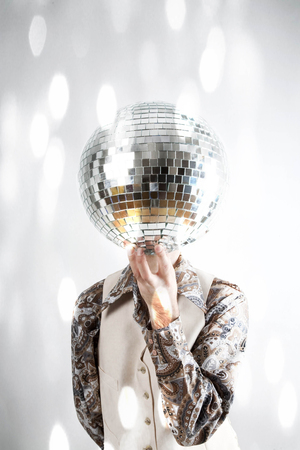 filtered image of a man holding a disco ball