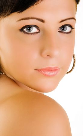 Portrait of beautiful young woman looking back over shoulder, isolated on white background.の写真素材