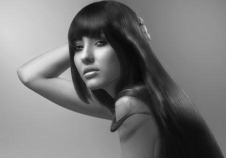 portrait of female face with long beauty glossy dark hairの写真素材