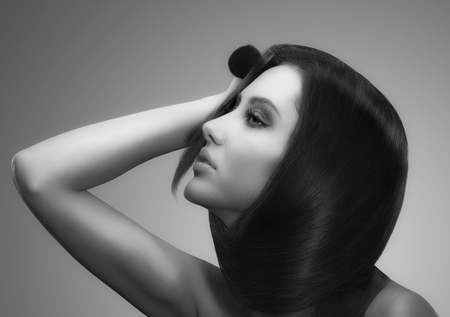 portrait of female face with long beauty glossy dark hairの写真素材