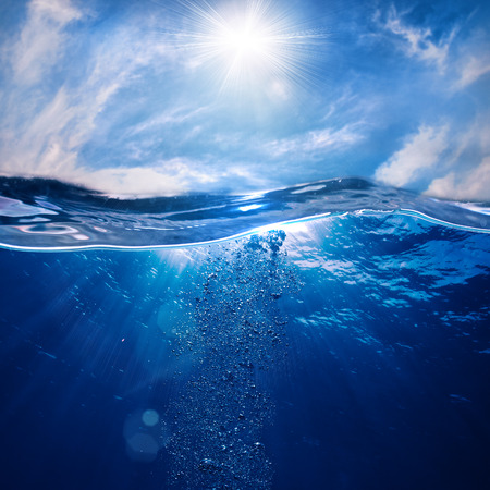 design template with underwater part and sunset skylight splitted by waterlineの写真素材