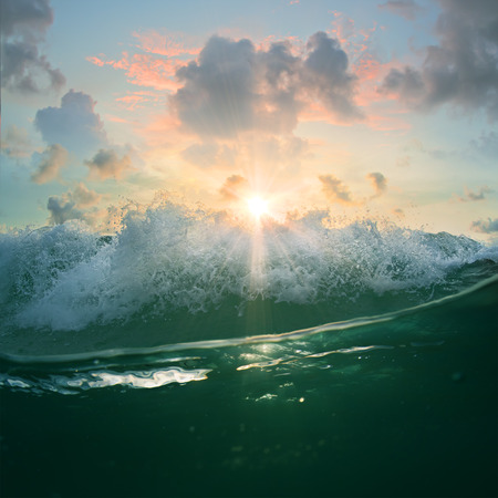 Beautiful sunset with ocean breaking wave and waterlineの写真素材