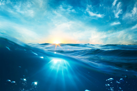 design template with underwater part and sunset skylight splitted by waterlineの写真素材