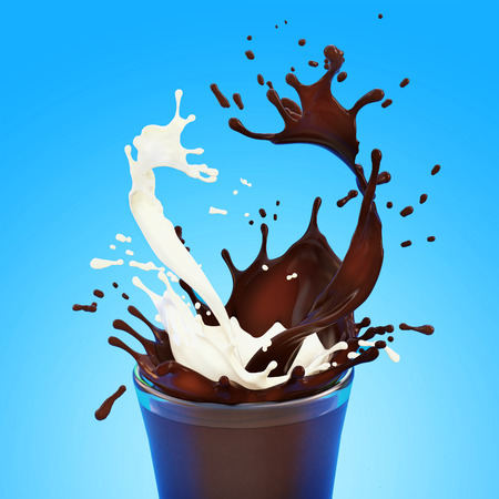 splashes of white fat milk and brown chocolate in transparent glass on blue backgroundの写真素材