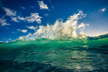 Sea water in sunlight rising green blue waveの写真素材