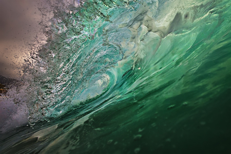 Ocean wave closing barrel. Water tube inside shot. Surfing spot with nobody on backgroundの写真素材