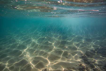 Underwater sand with caustic light. Copy space with nobodyの写真素材