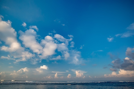 Morning seaview of shoreline with white waves in ocean. Beautiful clouds on the sky over the seaの写真素材
