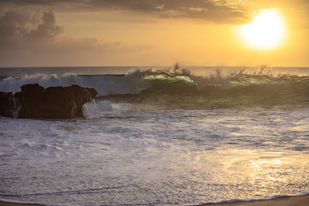 Sunset wave crashing against rock on a beach in Pacific oecan. Beautiful seascape sceneryの写真素材