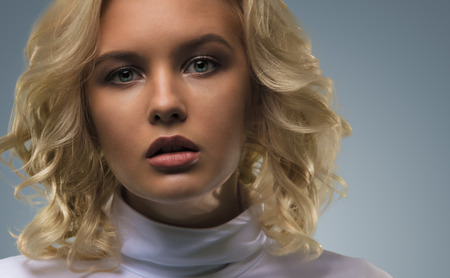 Blue eyed blonde girl in beauty style closeup portraitの写真素材