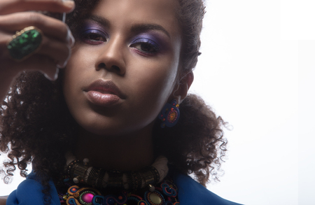 Creative closeup portrait of female face with jewelry, a fashion girl making selfieの写真素材