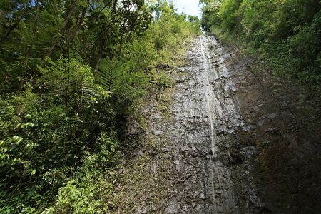 Stone wall with track of waterfall on itの写真素材