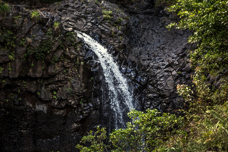 Water stream on rocky wallの写真素材