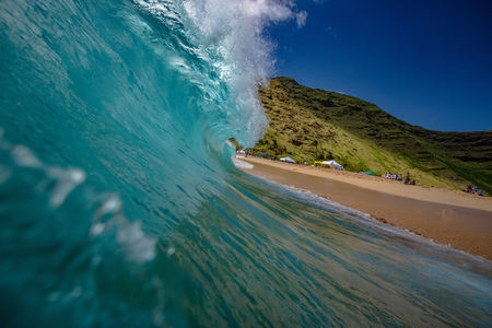 Shorebreak Ocean Wave in a shape of rip curl barrel, ready to crush against sand on a tropical beach. Hawaiian lifestyleの写真素材