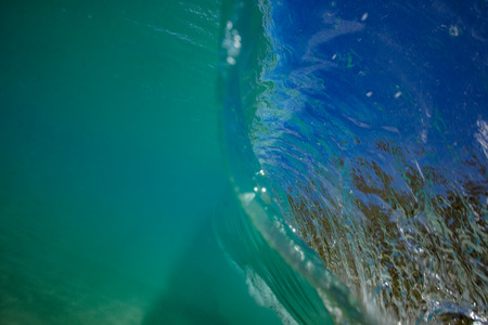 Ocean wave closing in barrel. View from inside with underwater part and a lip surfaceの写真素材