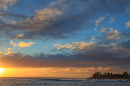 Beautiful ocean sunset with big waves in Hawaiiの写真素材