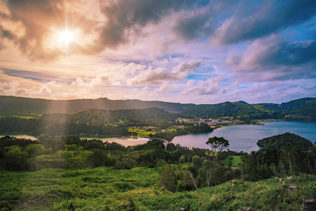 Beautiful sunset volcanic lake among mountains with green lush and trees in Ciete Cidades valley in Azores at San Miguel Island,
sunlight and clouds on the sky on backgroundの写真素材