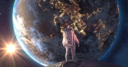Astronaut Neil Armstrong, spacewalk on the Moon surface watching planet Earth from space.の写真素材