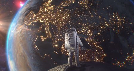 Astronaut Neil Armstrong, spacewalk on the Moon surface watching planet Earth from space.の写真素材
