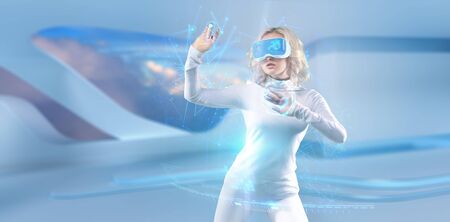 Futuristic girl working in virtual reality goggles with big data information, media technologies for businessの写真素材