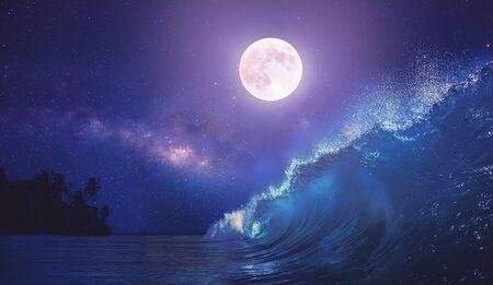 Beautiful night ocean scenery with surfing wave and full moon on tropical backgroundの写真素材