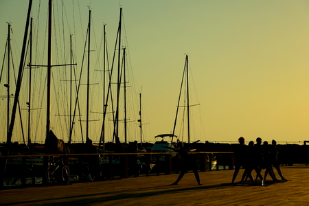 stretching at sunset beach in tel avivの写真素材