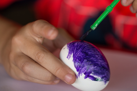 easter egg painting with brushの写真素材