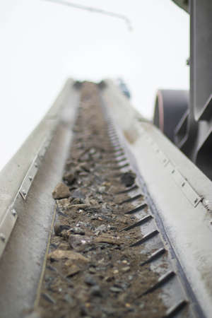 crushed stones on a chevron conveyor belt