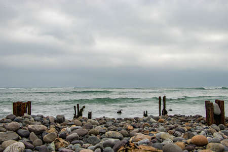old rusty irons on the rocky beach of limaの写真素材