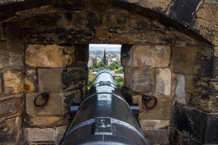old cannon pointing edinburgh city from castleの写真素材