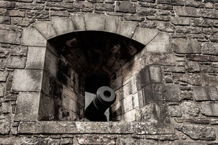 cannon in a castle pointing from a peepholeのeditorial素材