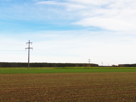 High voltage power line in the meadowの写真素材