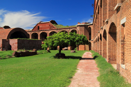 A brick trail allows visitors to safely tour the interior grounds of historic Fort Jefferson in Dry Tortugas National Park, Florida Keysのeditorial素材