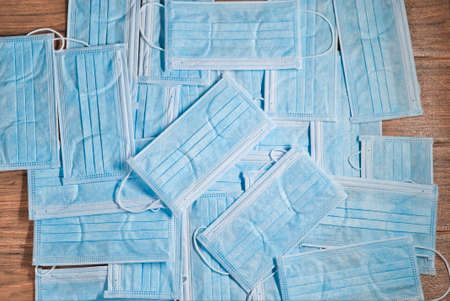 Many blue disposable surgical face masks with ear-loop abstractの写真素材
