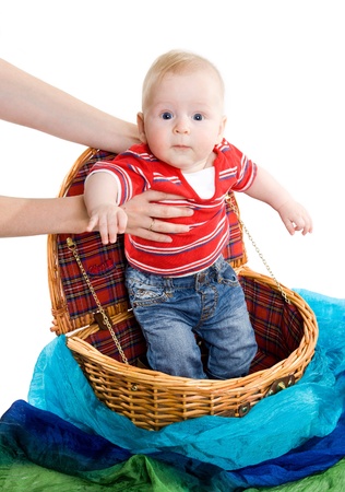 The cute child getting from a wickered baskeの写真素材