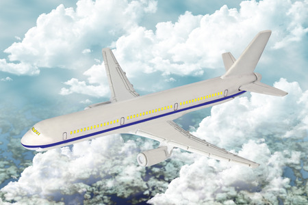 White passenger plane flying in the blue sky.の写真素材