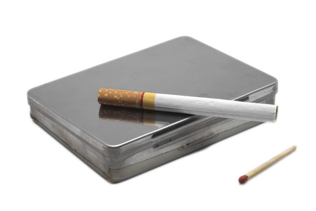 Cigarette on a box with matchstick の写真素材