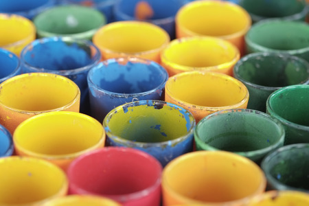 Stack of dirty colored cup.