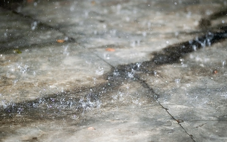 Drops of heavy rain on the area have cracks.の写真素材