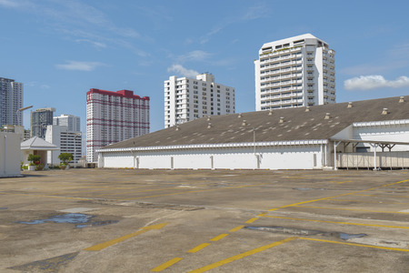 Empty parking space on city background.の写真素材