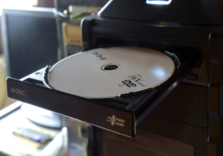 Close up of disc instert to DVD or CD player of computer.のeditorial素材