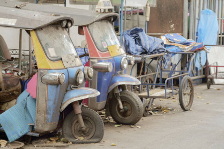 Old and dirty taxi (tuk tuk) was abandoned on roadside.