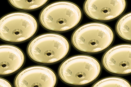 Old chandelier lamp, under view, on black background.の写真素材