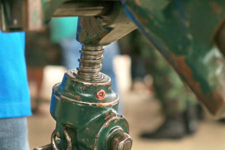 Close up screw height adjustment of old artillery gun.