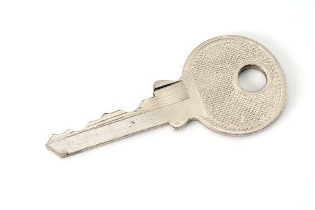 Silver key on white background.の写真素材