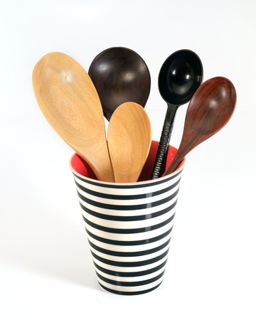 Wooden spoon in ceramic glass on white background.の写真素材