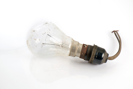 Old and dirty light bulb on white background.の写真素材