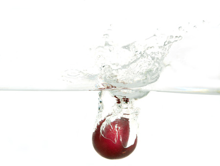 Water splash and sherry on white background.の写真素材