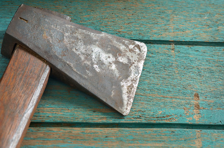 Old and dirty axe on wood background.の写真素材